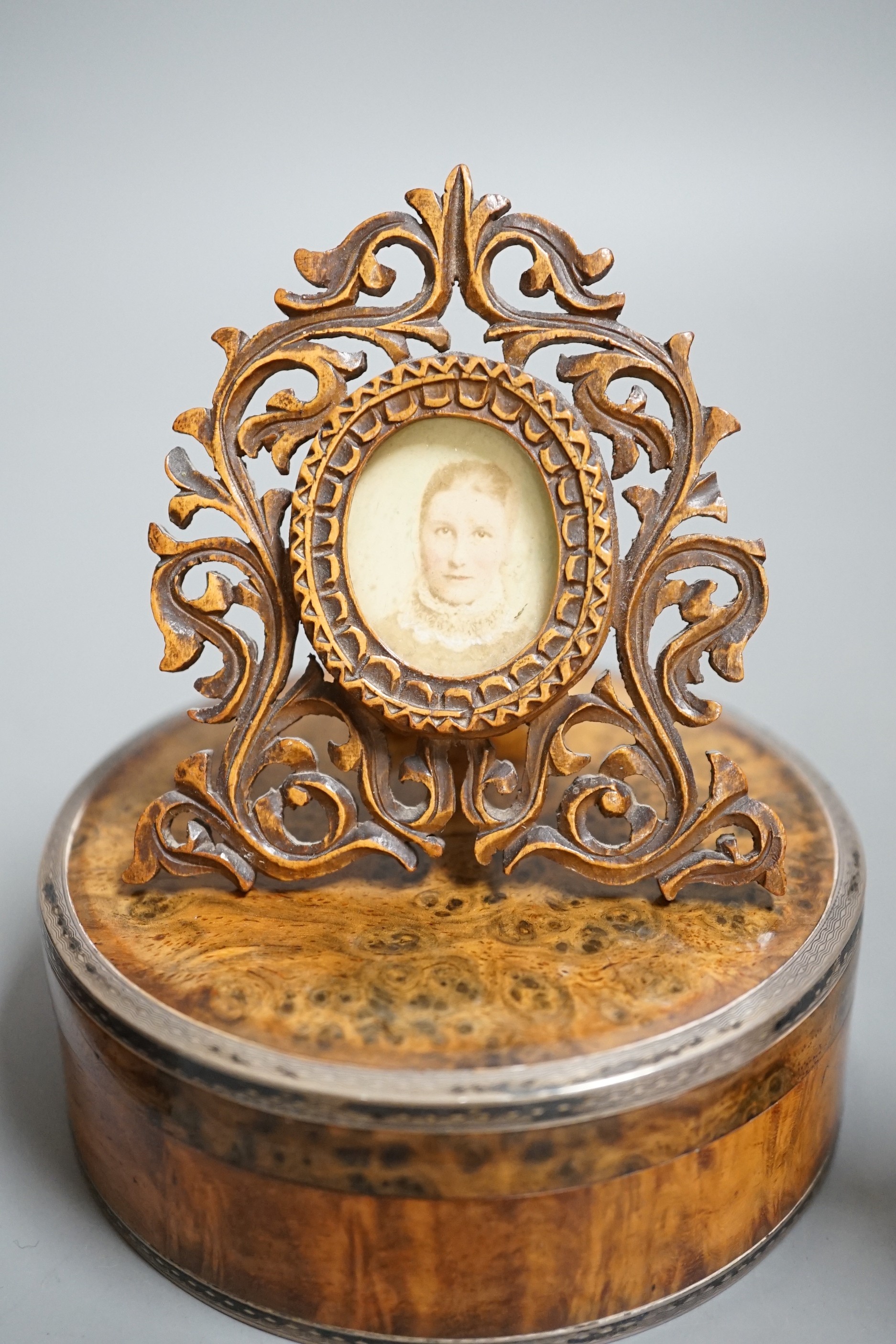 A 19th century circular white metal mounted burr wood snuff box and assorted small carvings